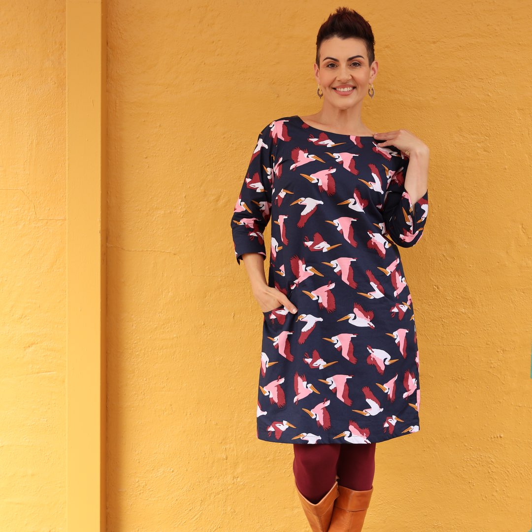 woman wearing long sleeve navy blue dress with pelican bird print