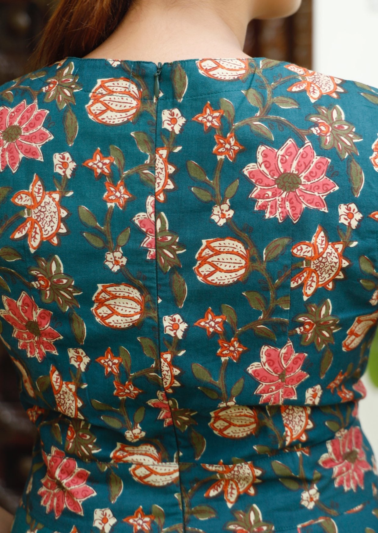 Back image of 100% cotton floral print dress with zipper at the centre of the back.