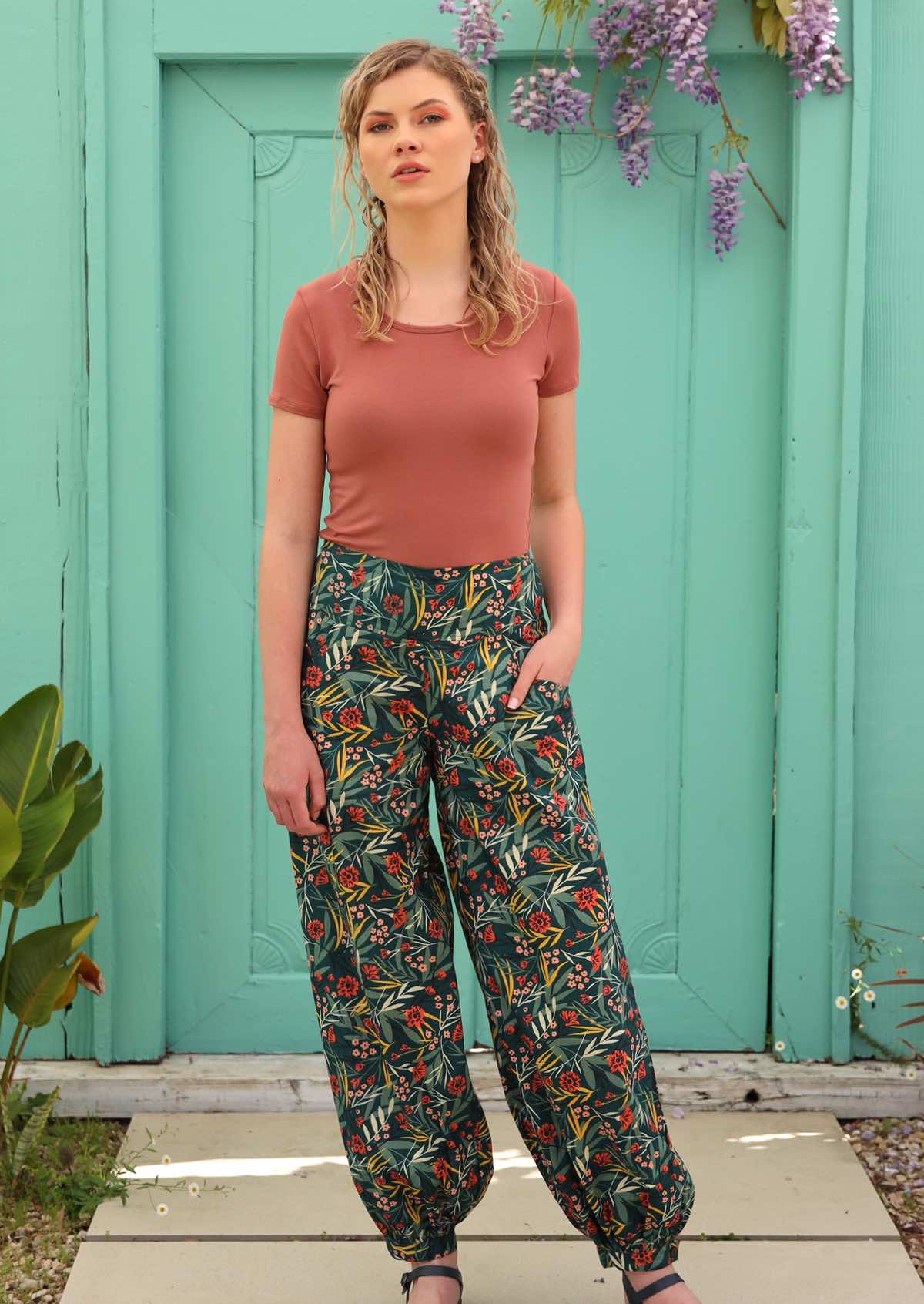 Model pairs 100% cotton pants with a short sleeve top. 