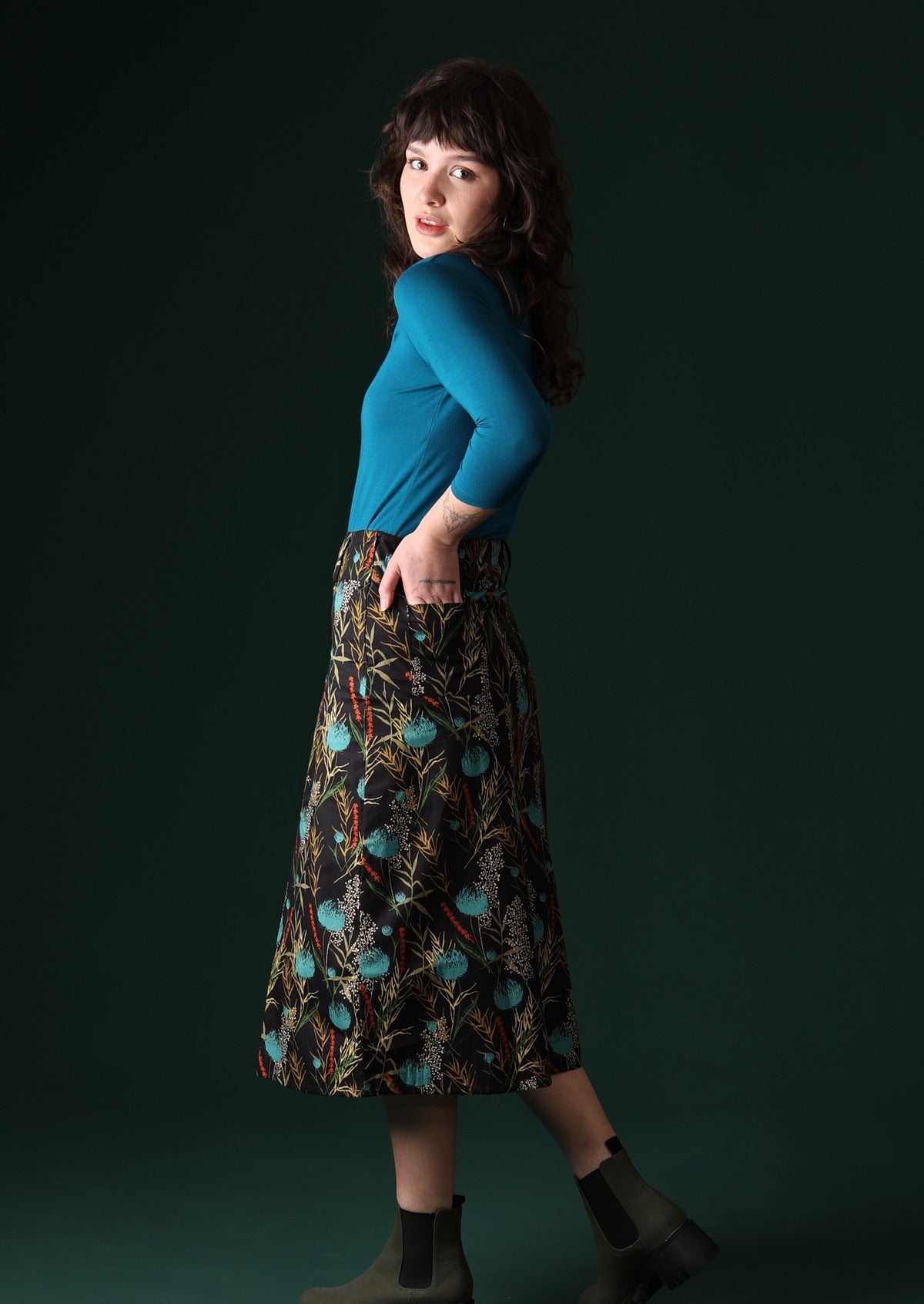 Model wears cotton midi skirt with back pockets