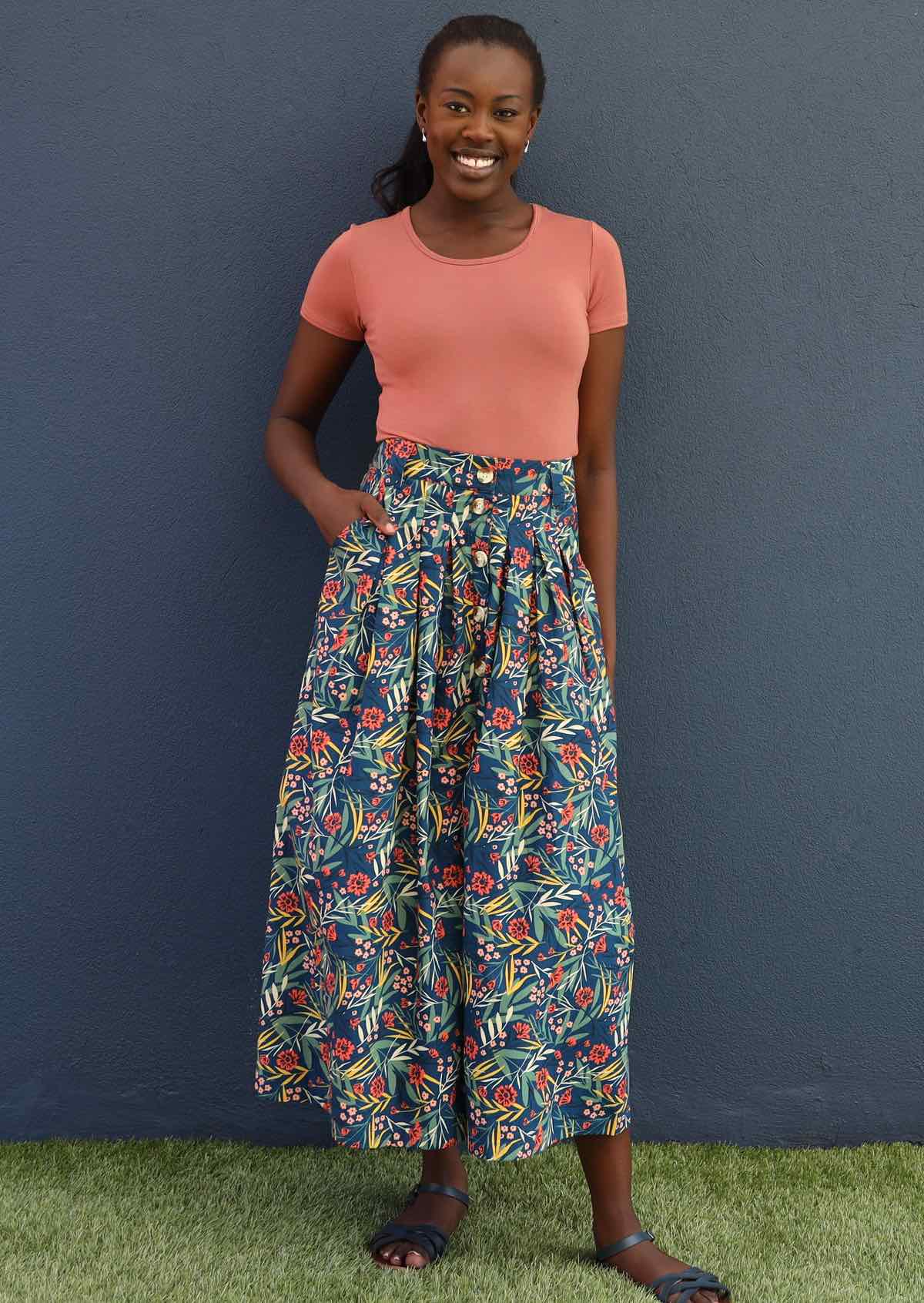 Model wears blue floral cotton button through skirt with pockets