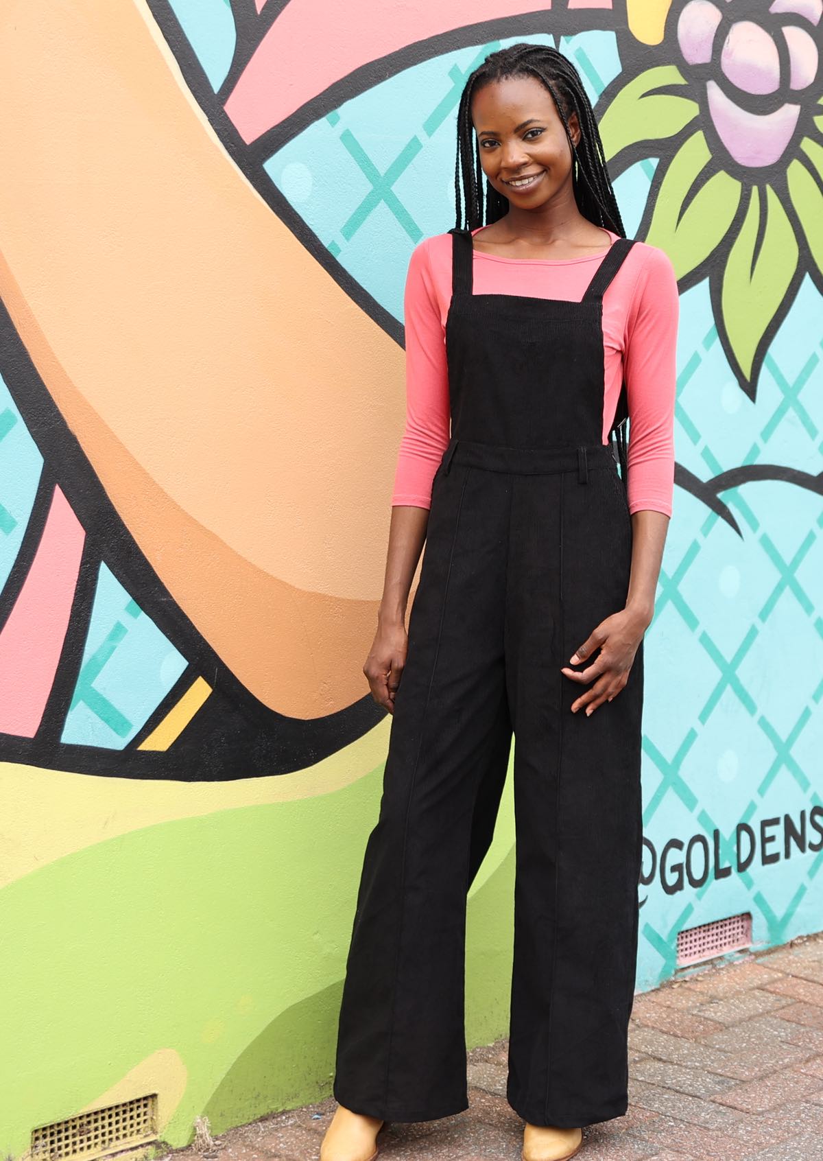 Woman wearing 100% cotton corduroy overalls with pockets in black