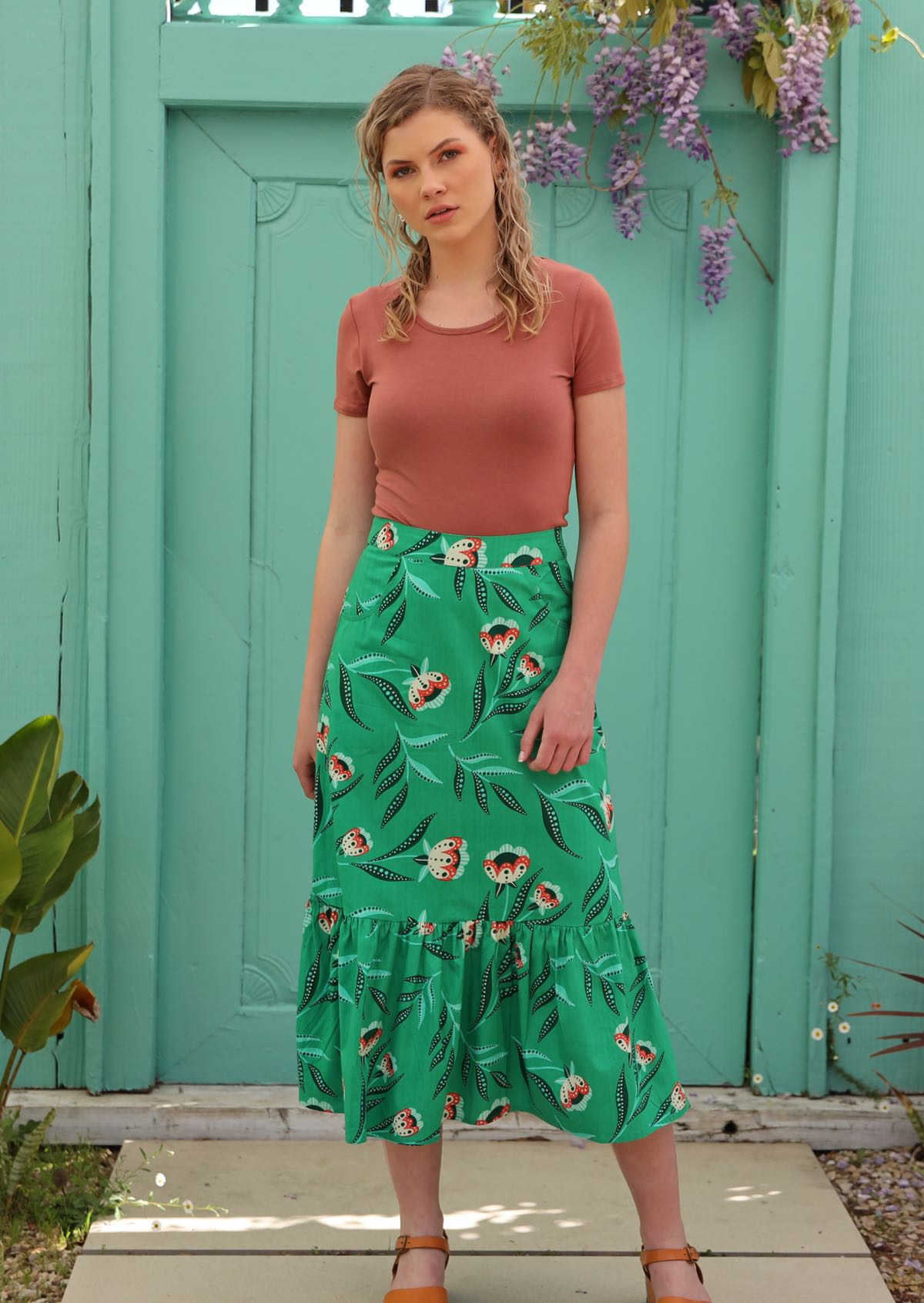 Model wears mint green pencil skirt with ruffle