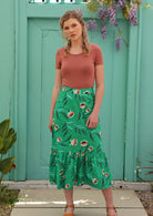Model wears mint green pencil skirt with ruffle