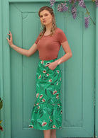 Model wears cotton midi length skirt with pockets and ruffle