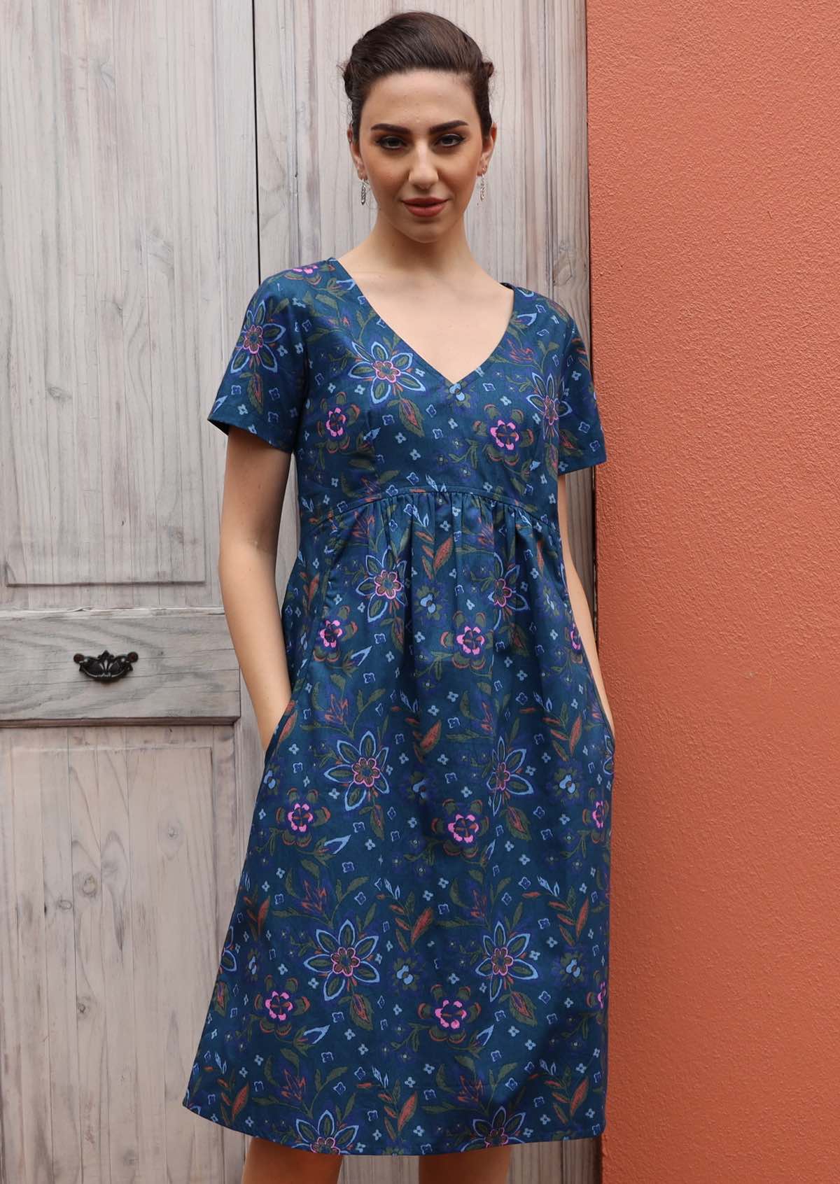 Model wears a short sleeve cotton dress with pockets. 