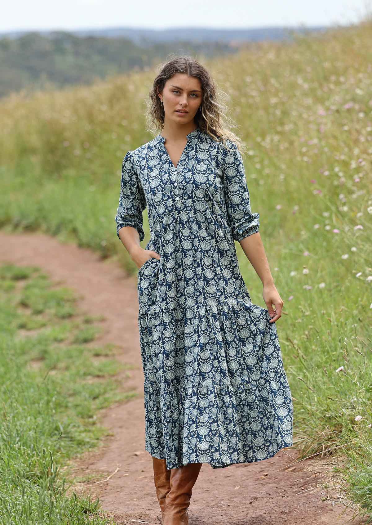 woman with hill in background wearing long sleeve block print cotton maxi dress in Indigo Blue