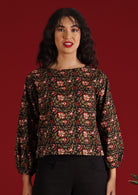 Model with dark hair and red lipstick in Isla Top Wild Rose black floral cotton boho top