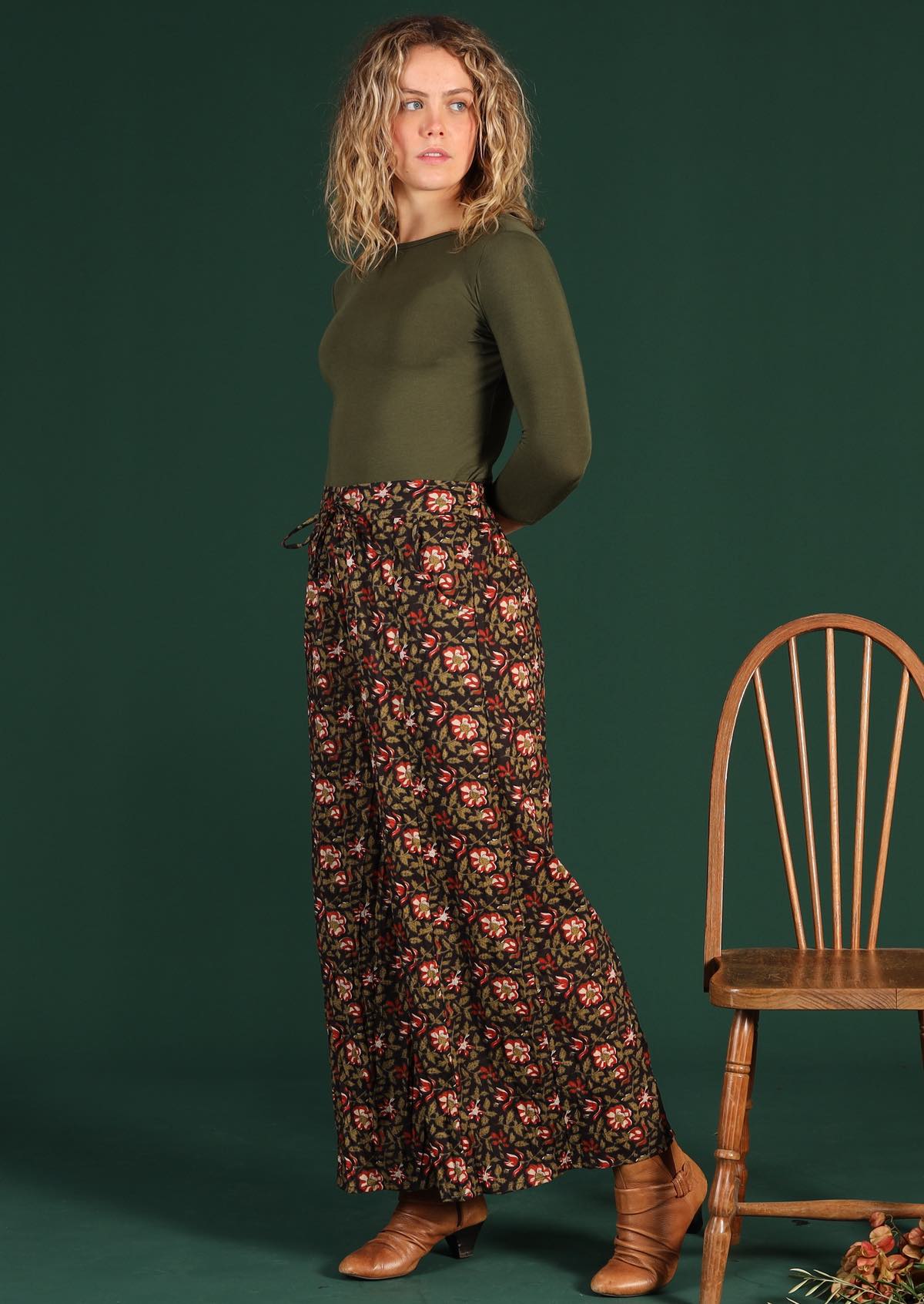 Model in Janis Pants Wild Rose wide legged cotton women's pant with pockets and long sleeve army green top