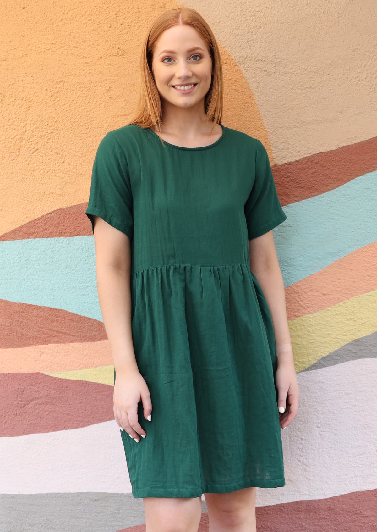 model standing with green dress short sleeves oranger hair