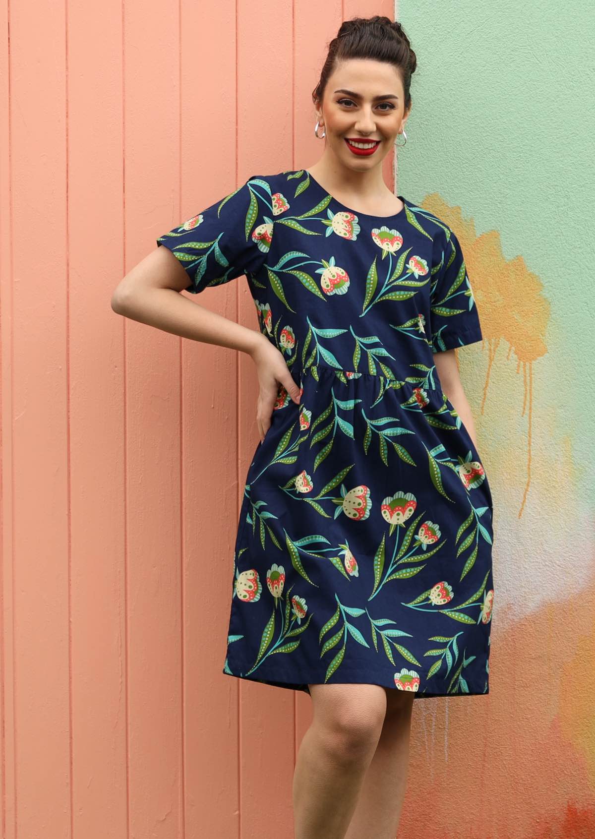 Model wears 100% cotton dress with a floral print. 