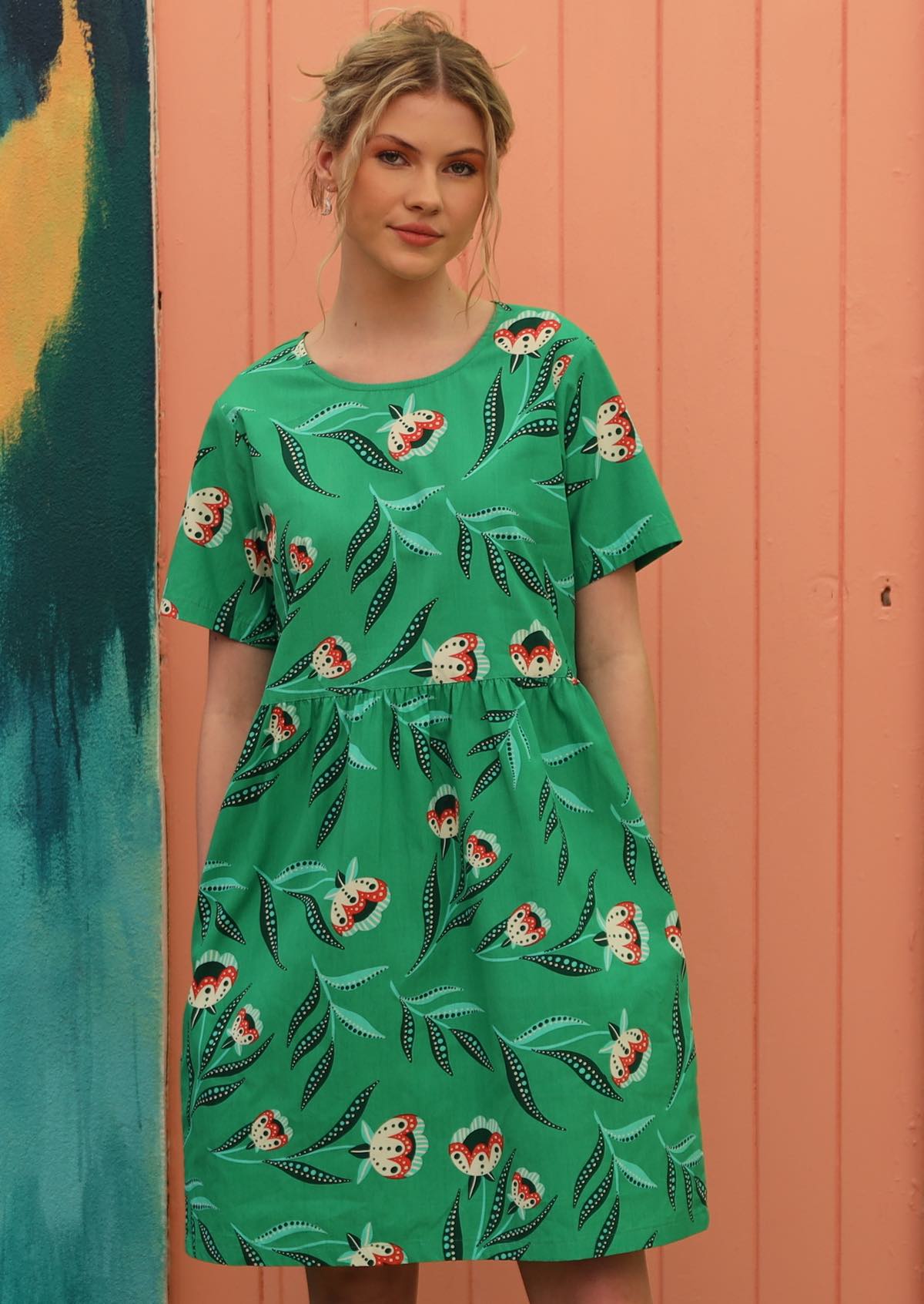 Model wears green cotton dress with T-shirt sleeves