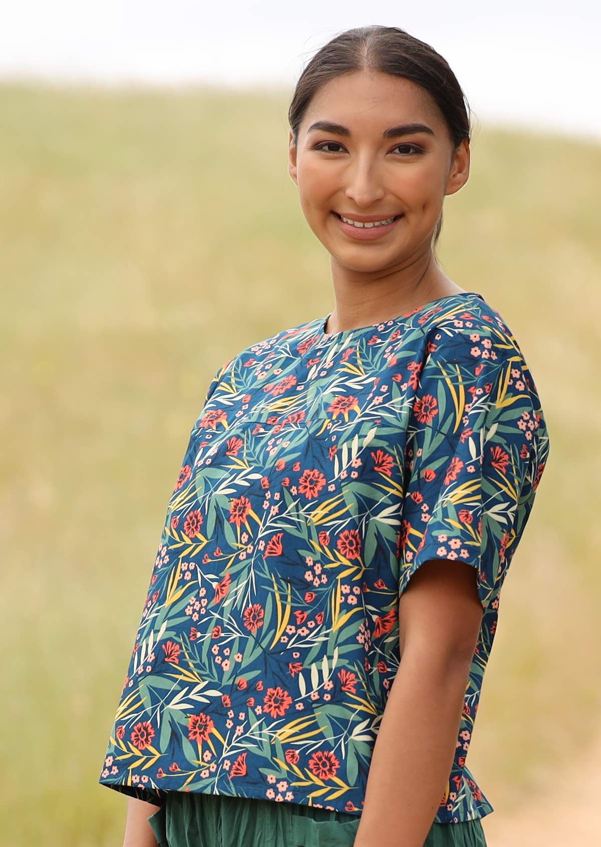 Model wears cotton floral print short sleeve top with blue base