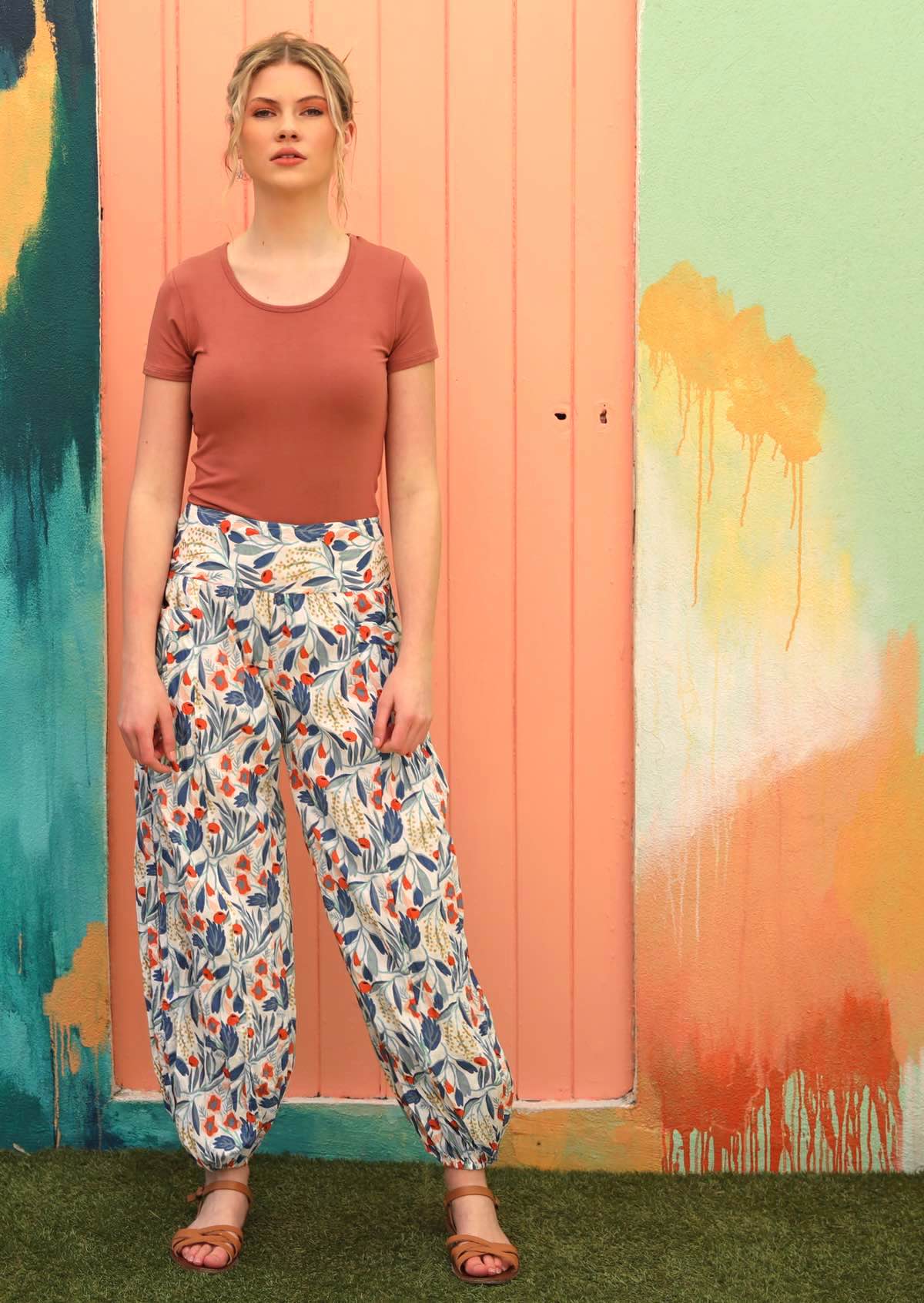 Model wears floral pants with elasticated waist and ankles. 