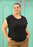 Woman with dark hair wearing a soft flattering fit black rayon jersey t-shirt.