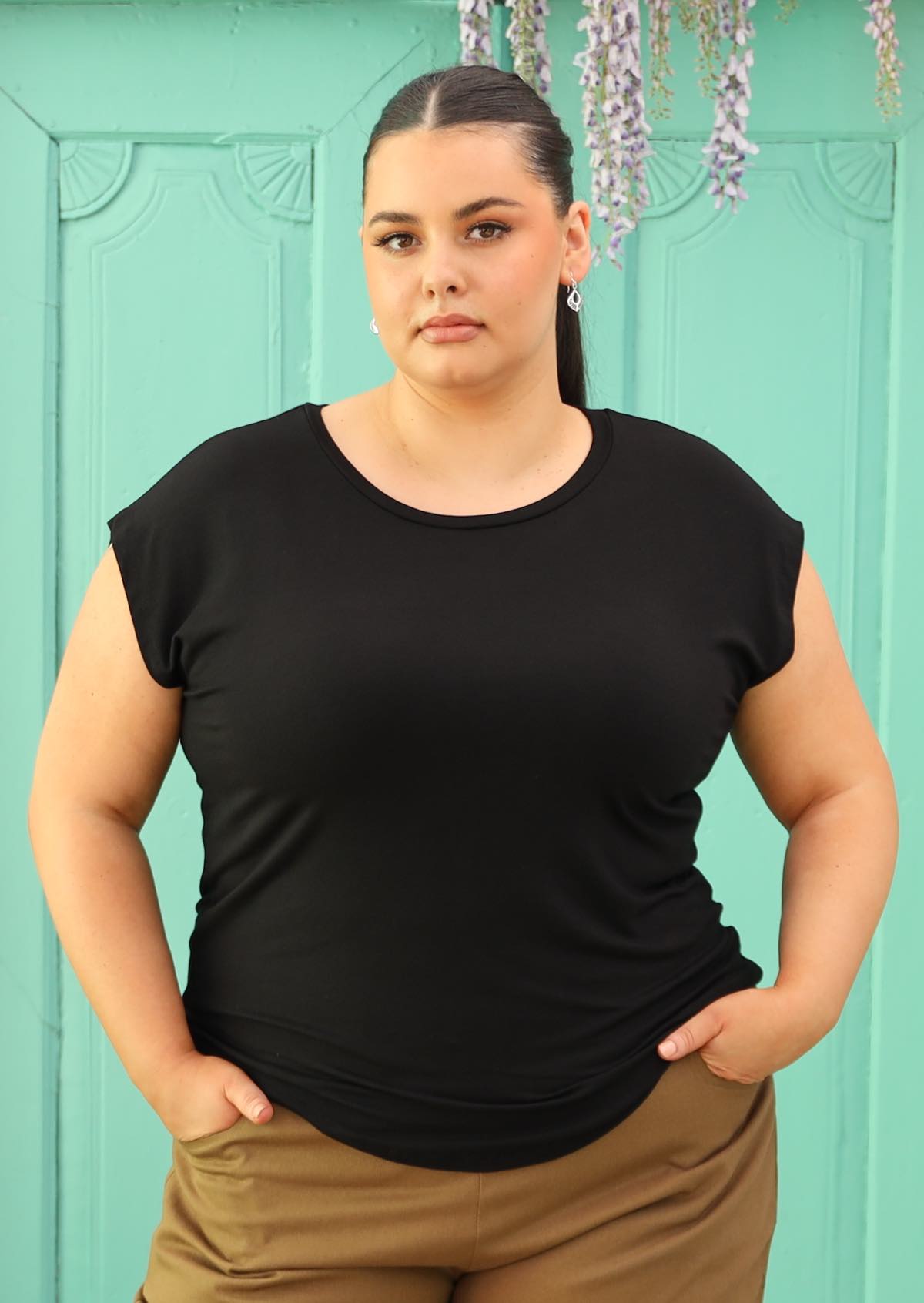 Woman wearing a soft flattering fit black rayon jersey t-shirt.