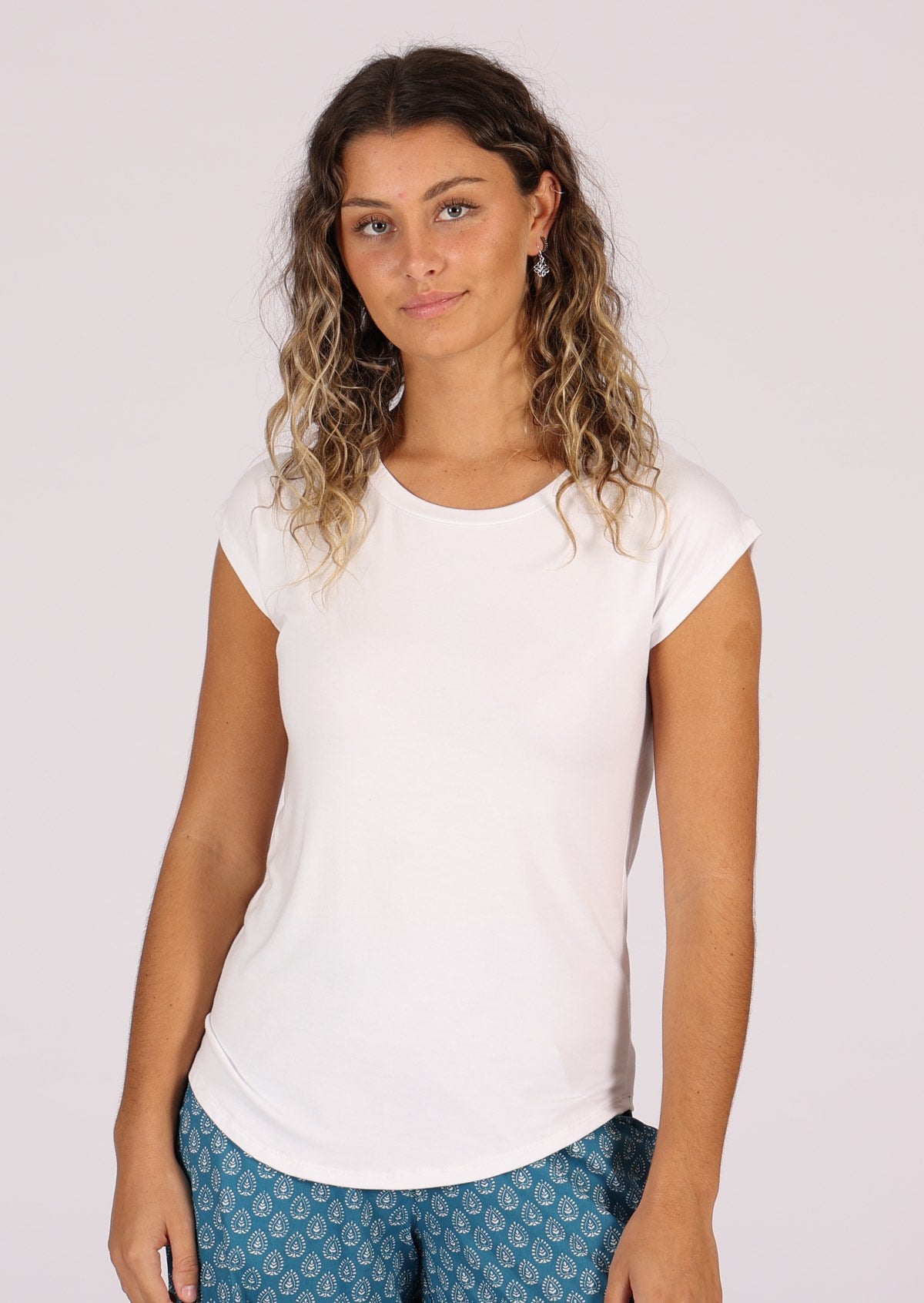 Woman wearing a soft flattering fit white rayon jersey t-shirt.