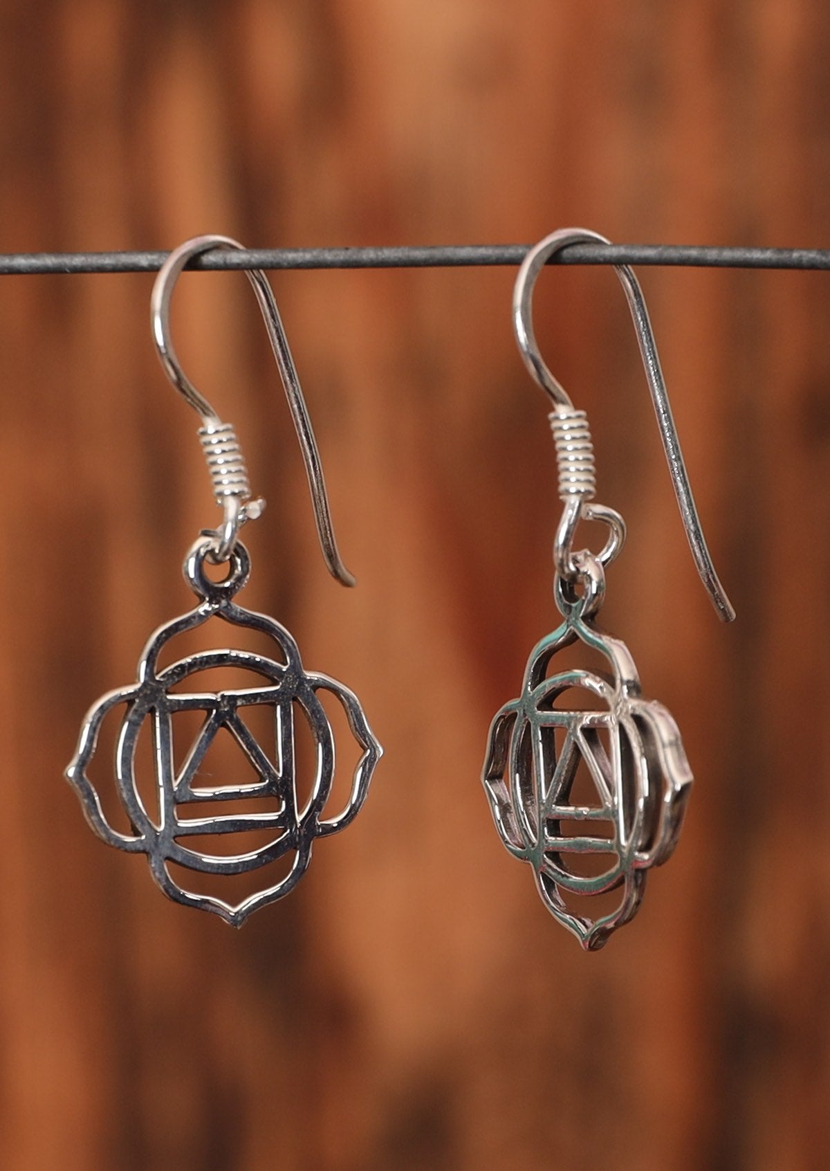 92.5% silver dangly chakra earrings on a wire for display.