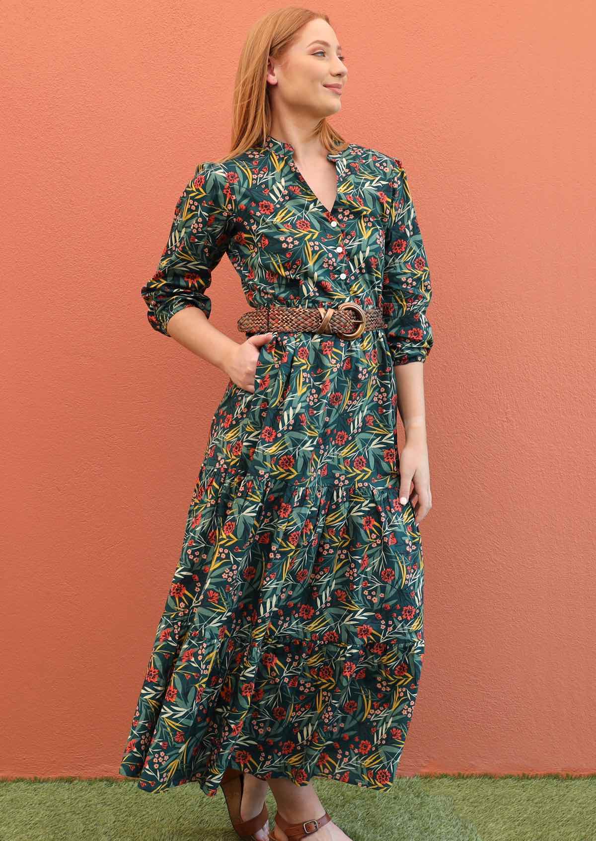 Model pairs maxi dress with a belt for a defined waist. 