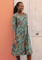 Model wears 100% cotton dress with a floral pattern and 3/4 length sleeves. 
