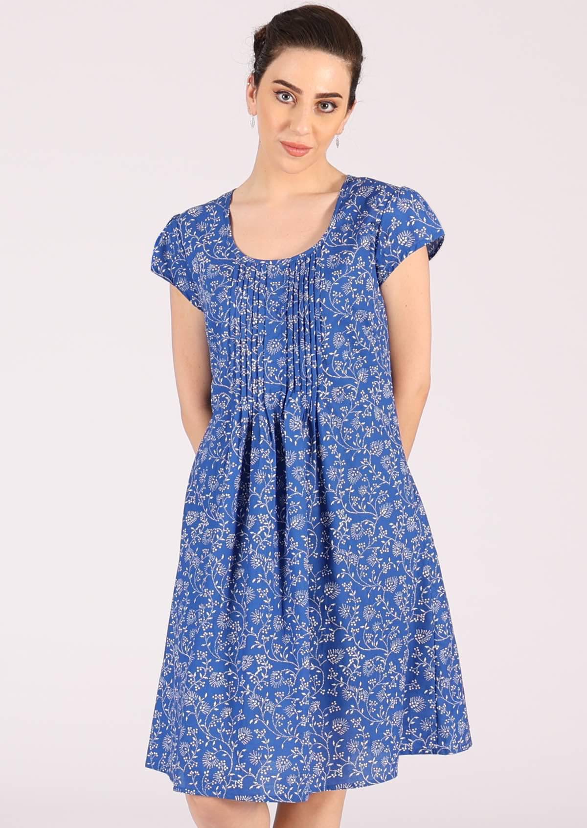 Small pleats across the bodice of this sweet blue base cotton dress
