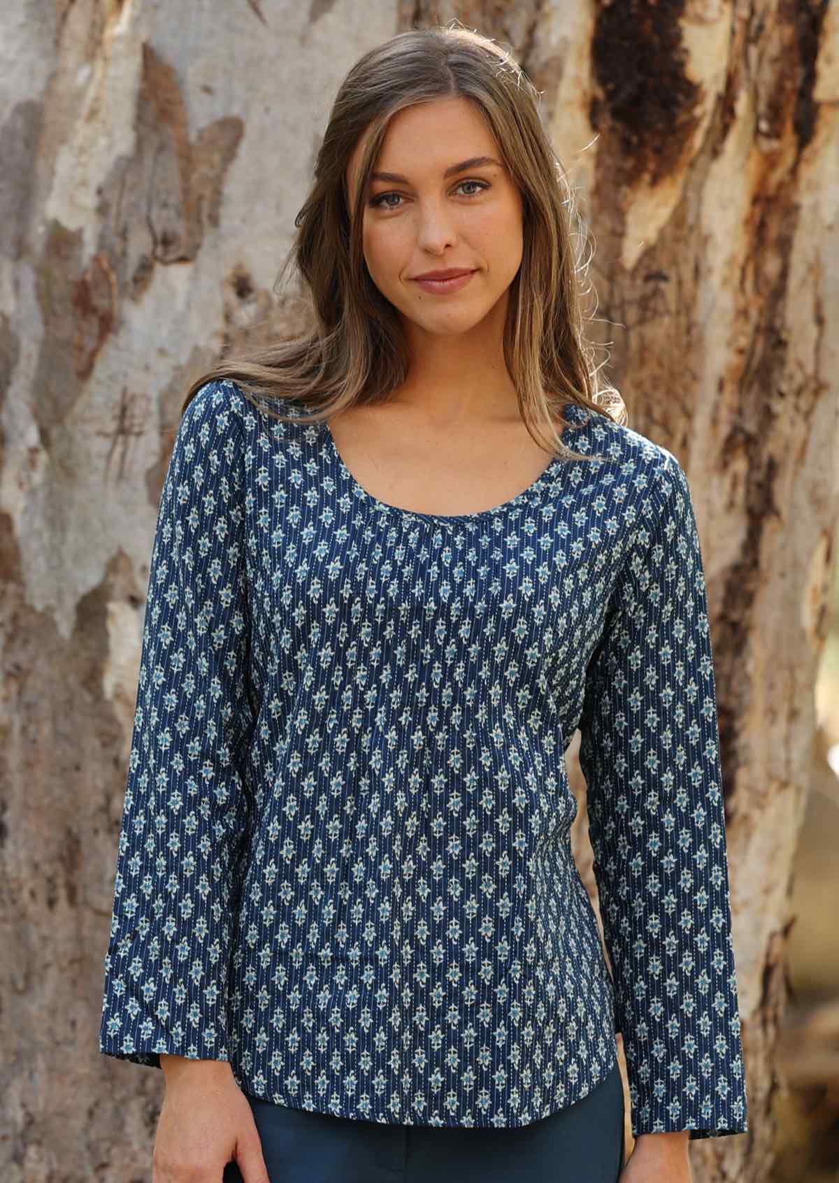 Model wears blue 100% cotton long sleeve top. 