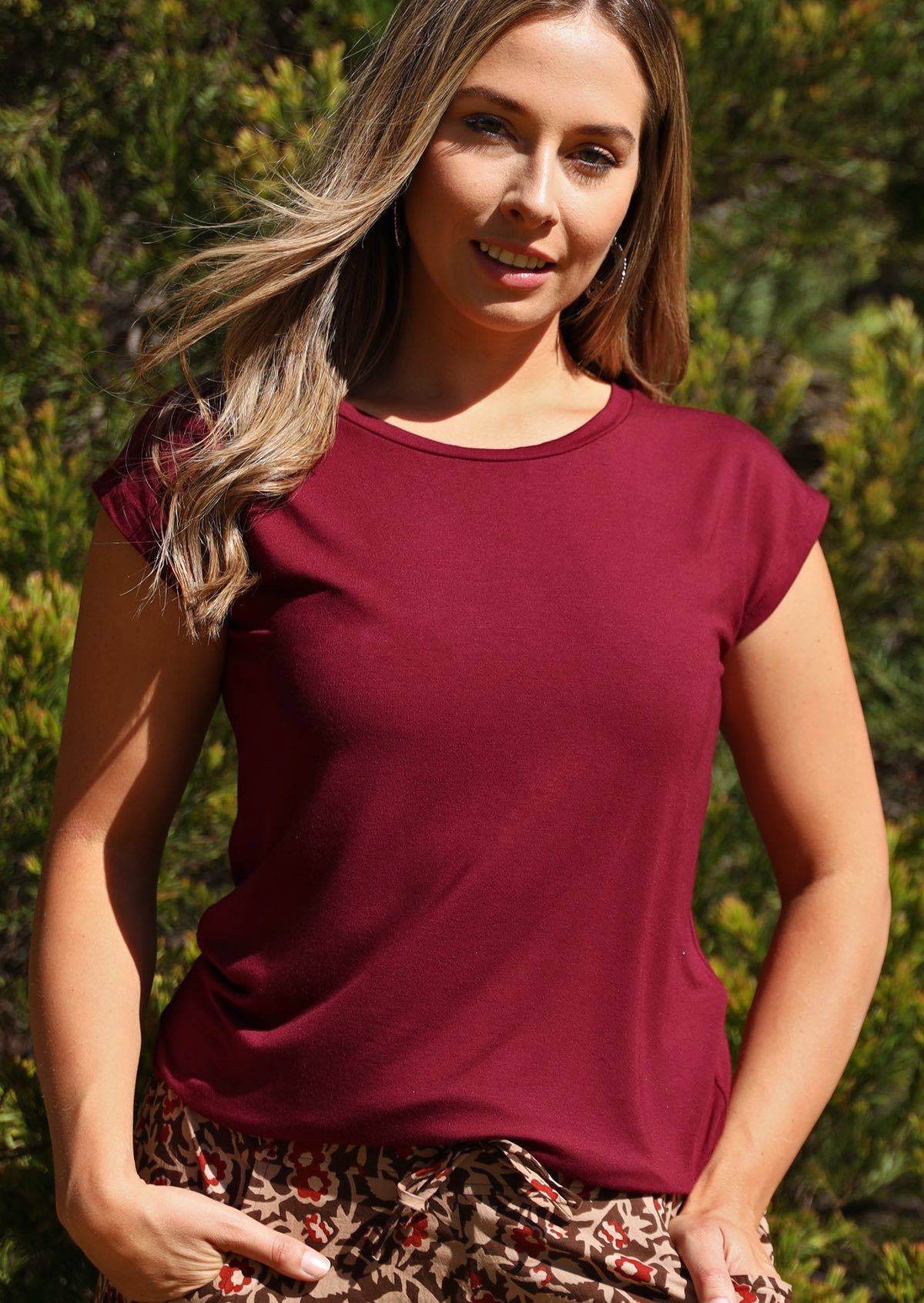 Woman with blonde hair wearing a soft flattering fit maroon rayon jersey t-shirt.