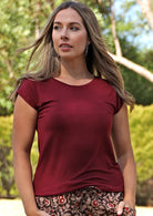 Woman wearing a soft flattering fit maroon rayon jersey t-shirt with floral pants.