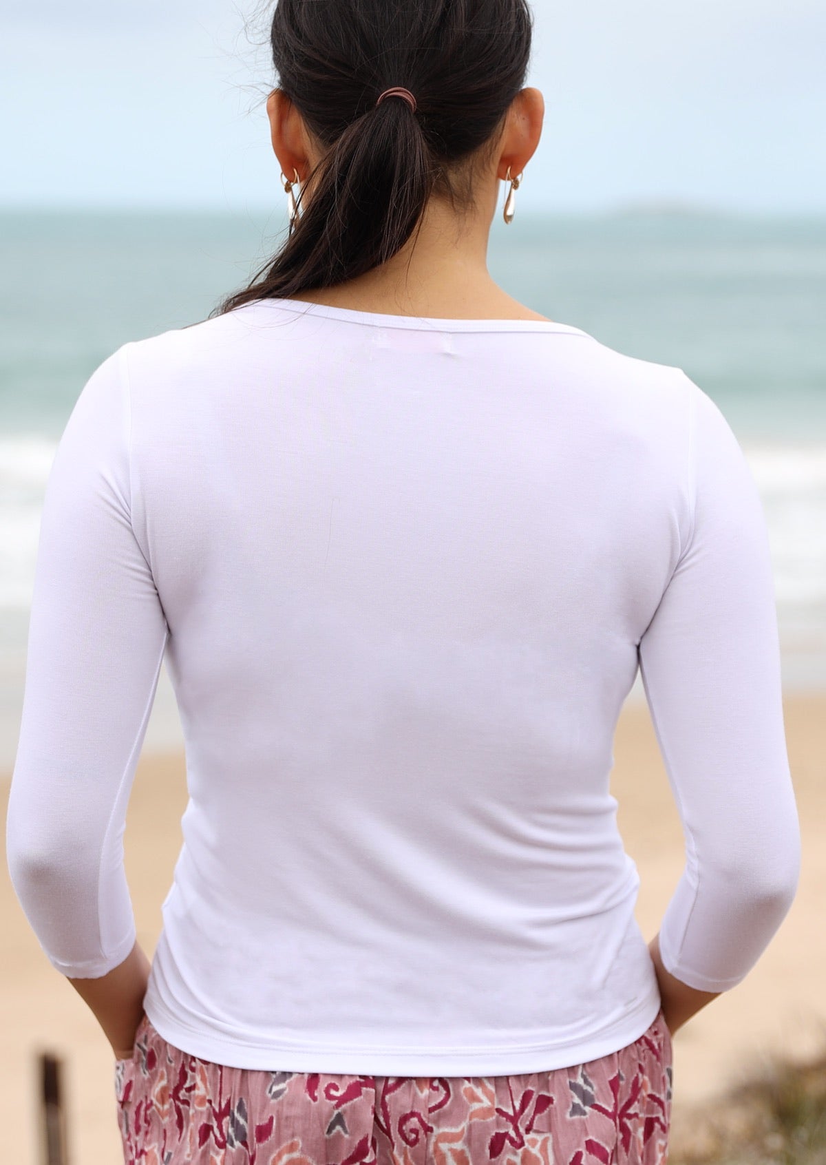 Back view of women's rayon boat neck white 3/4 sleeve top.