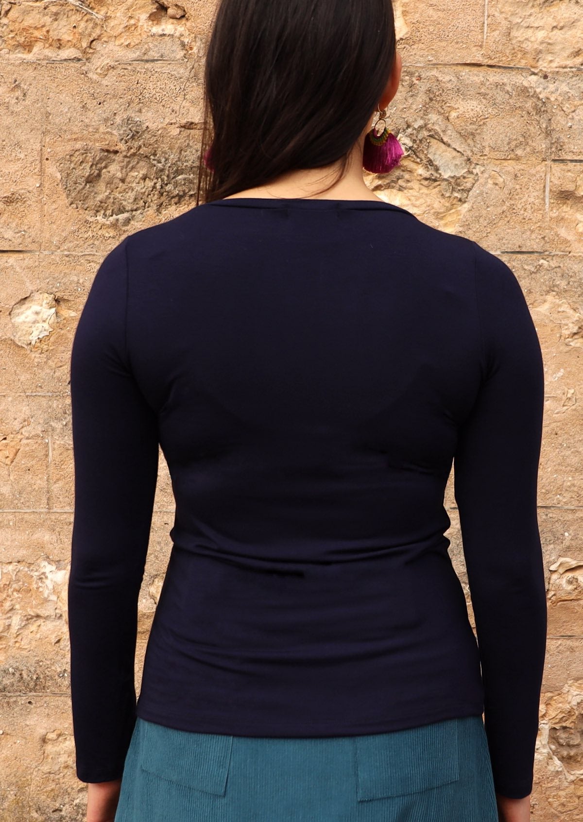 Back view of women's navy blue long sleeve stretch v-neck soft rayon top.