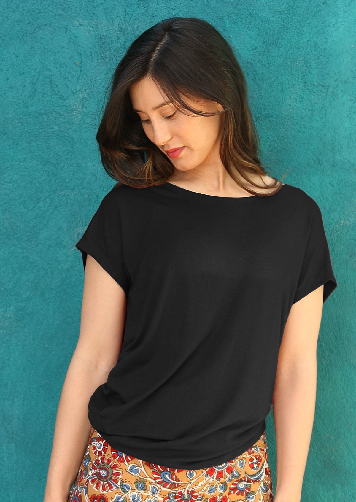 Woman wearing black rayon t-shirt with side drape