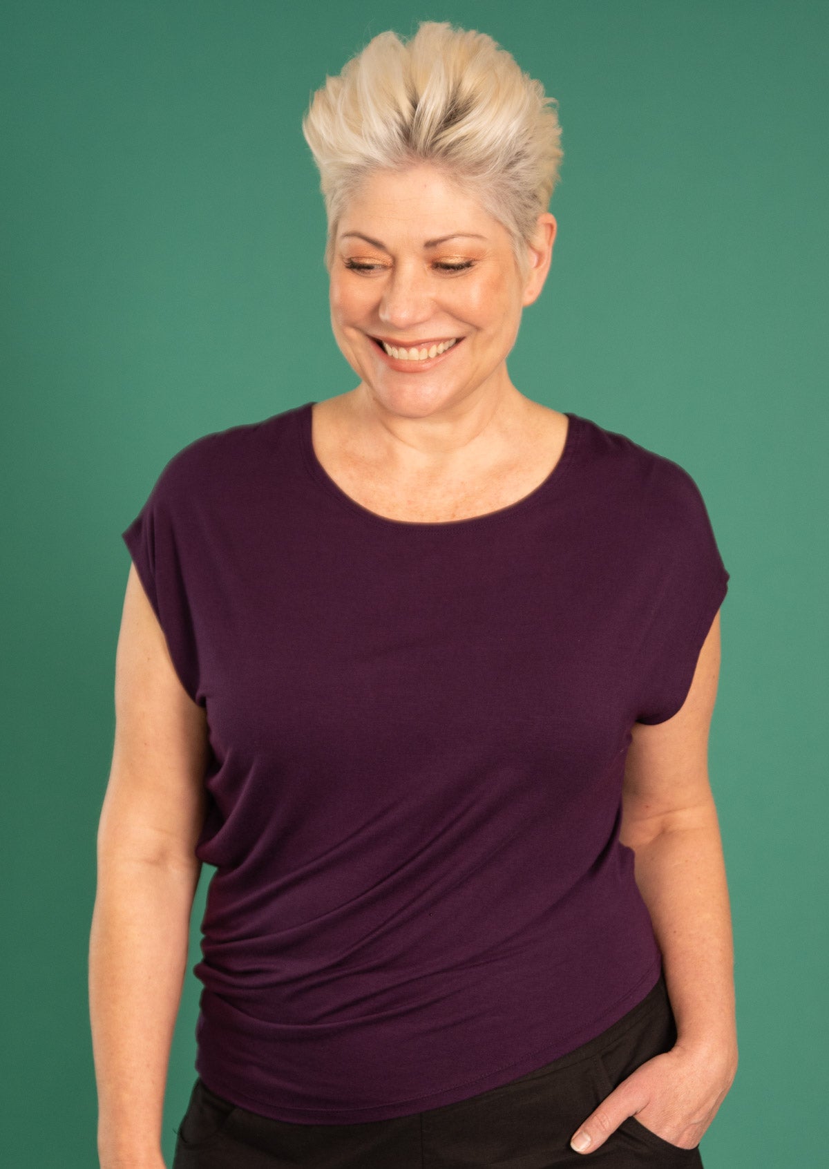 Woman wearing purple rayon t-shirt with side drape