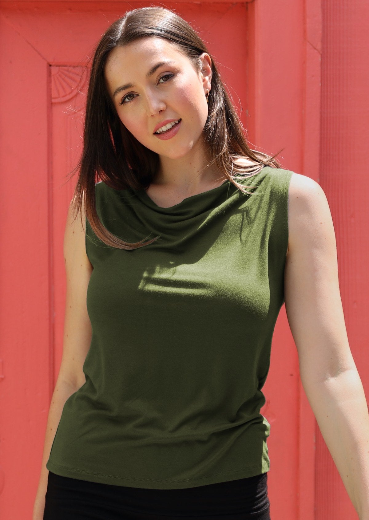 Woman wearing sleeveless cowl neck olive green singlet top 
