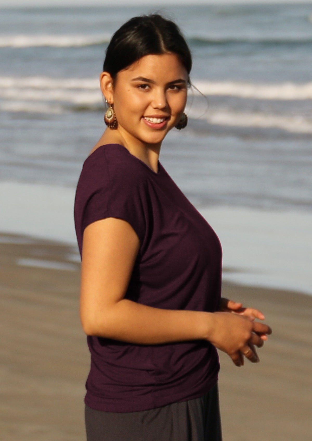 Woman wearing purple rayon t-shirt on the beach