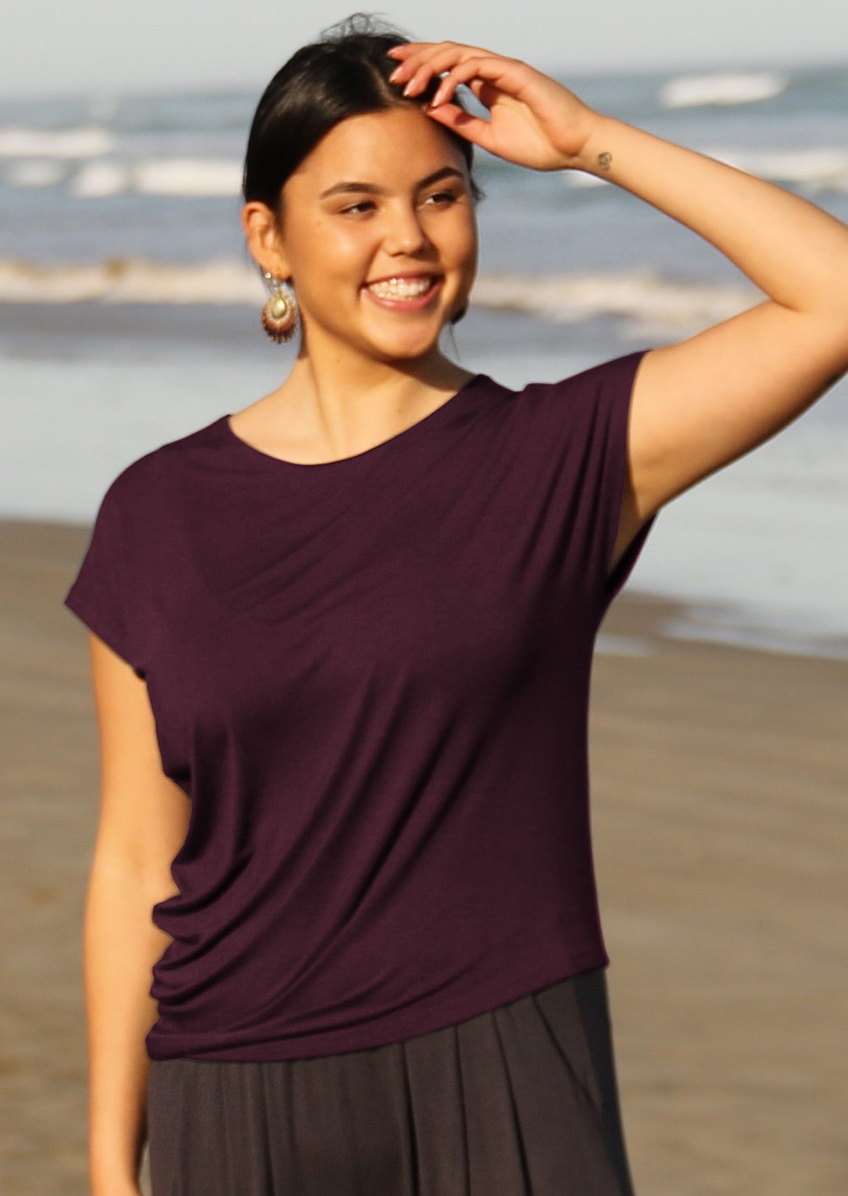 Woman with dark hair wearing purple rayon t-shirt