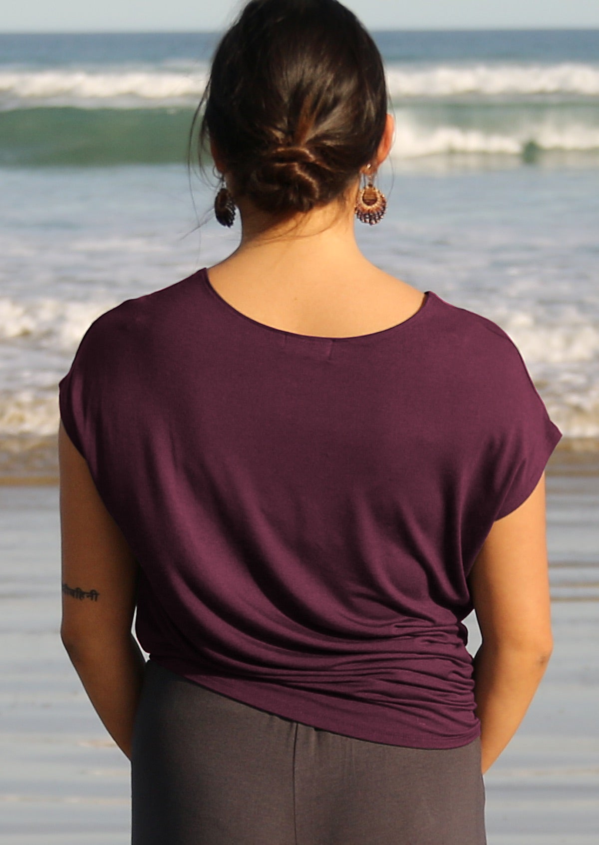 back view of woman wearing short sleeve purple t-shirt
