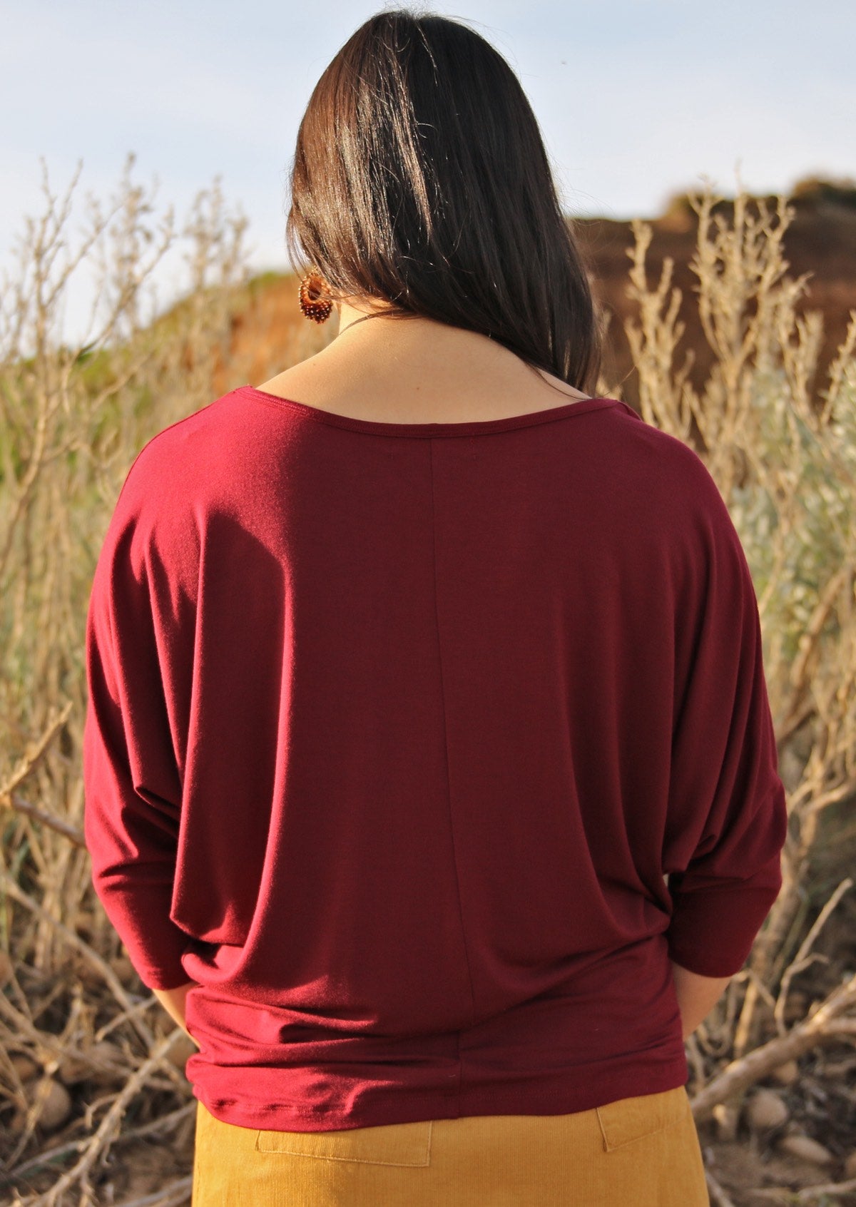 Back view of women's 3/4 sleeve rayon batwing round neckline maroon top.