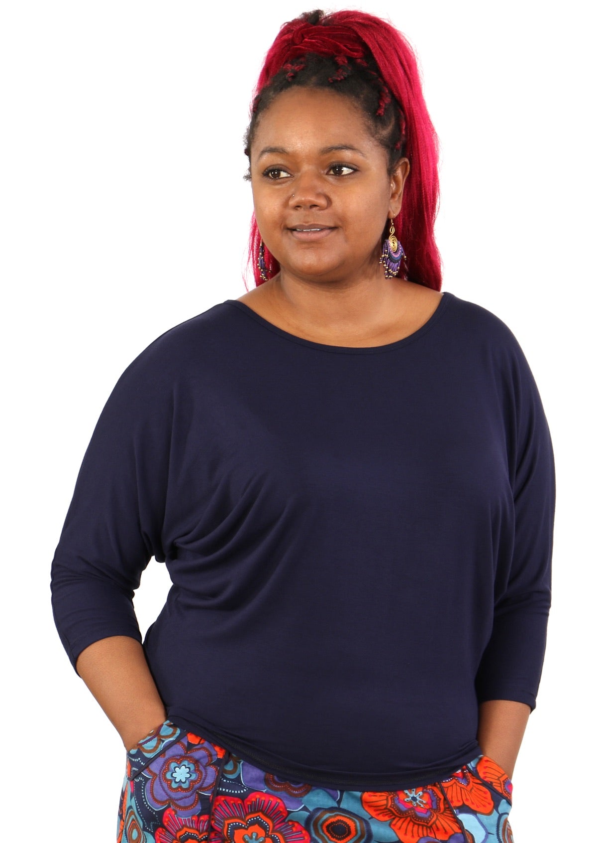 Woman with red hair wearing a 3/4 sleeve rayon batwing round neckline navy blue top.