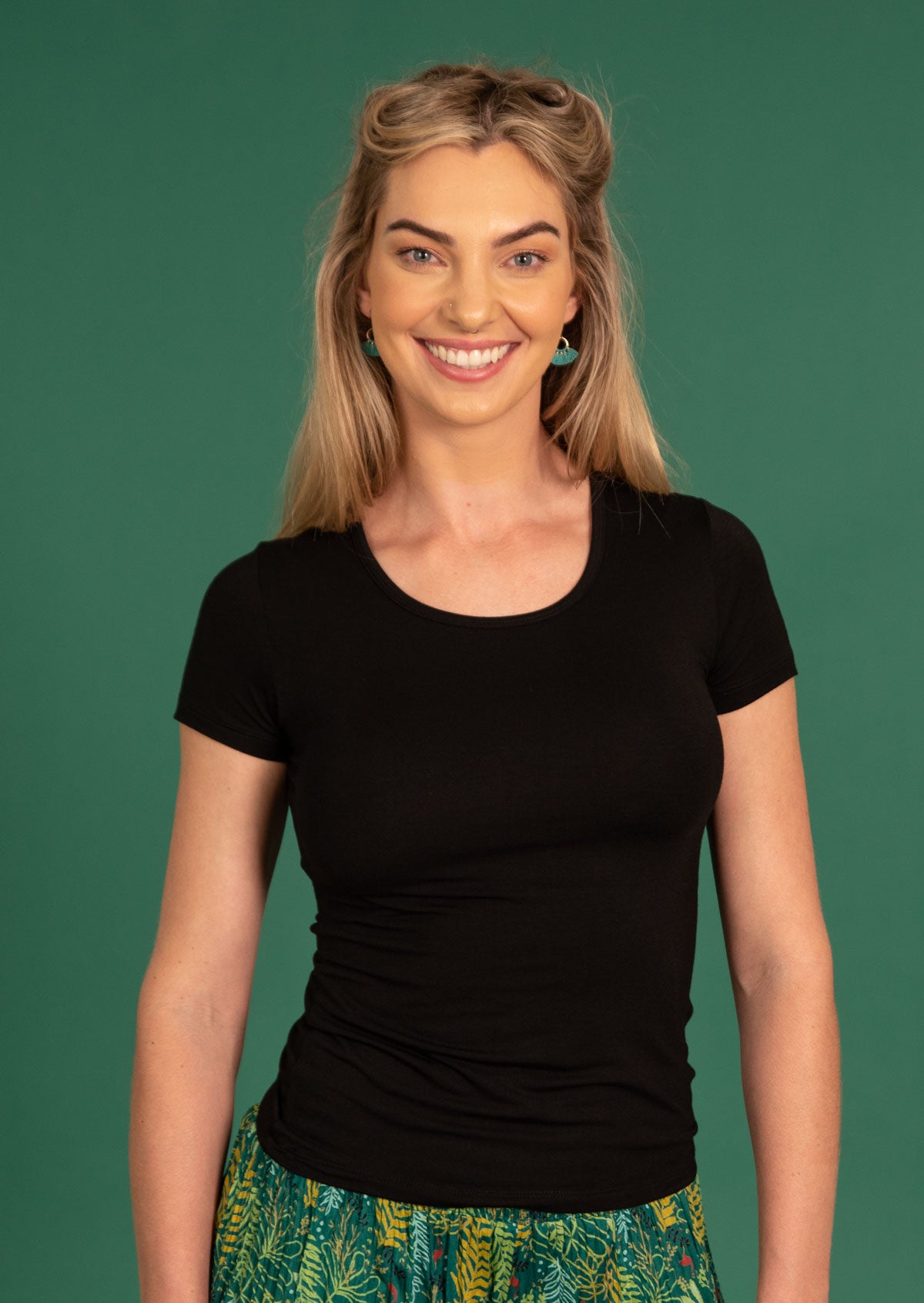 Woman wearing a black stretch rayon t-shirt.