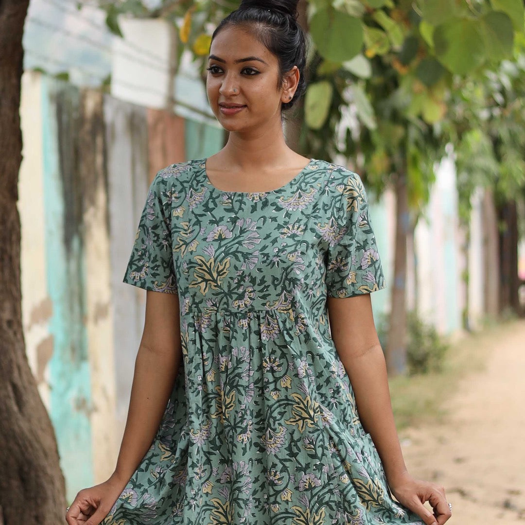 woman wearing green Indian print cotton dress with pockets and sleeves