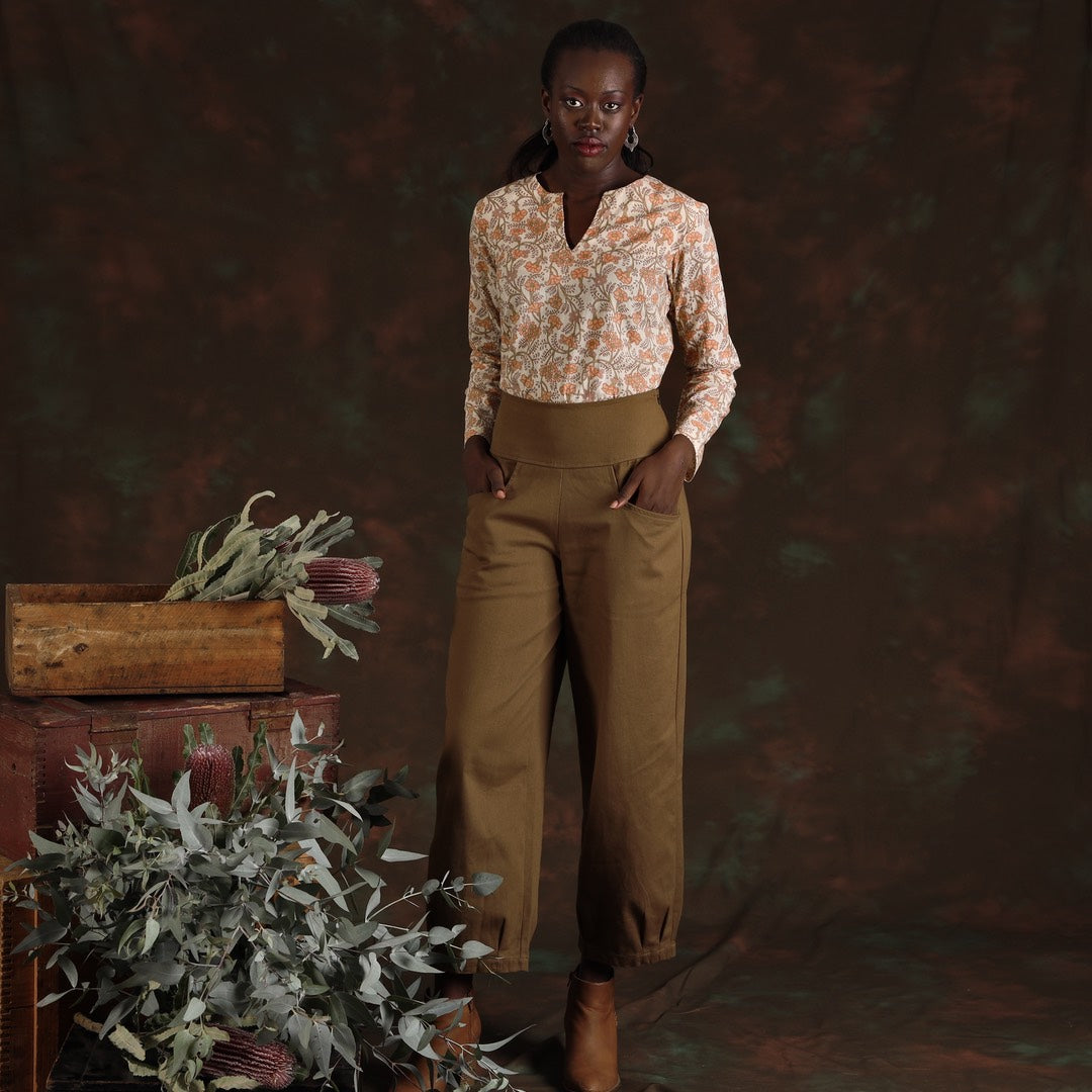woman wearing khaki green cotton drill pants and floral cotton blouse