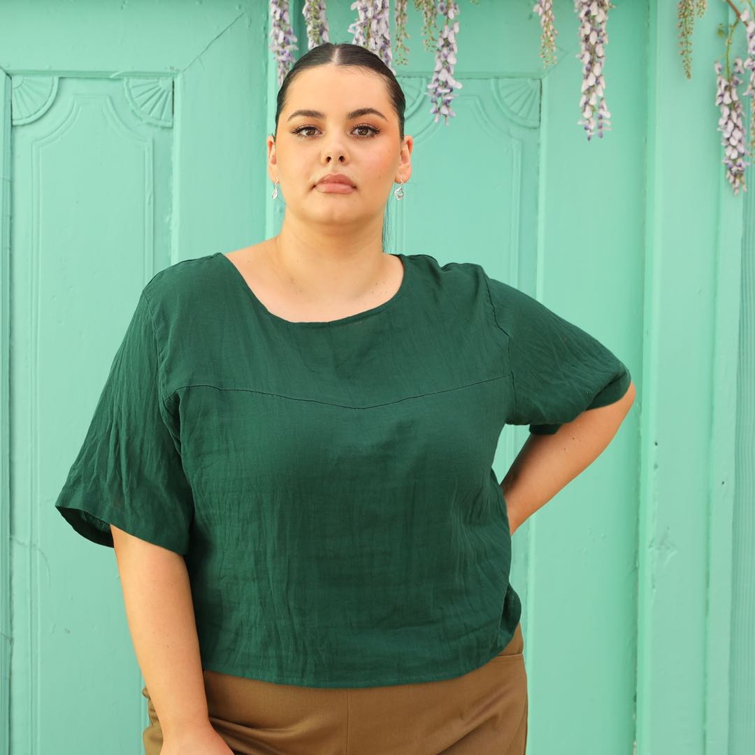 plus sized model in green cotton top