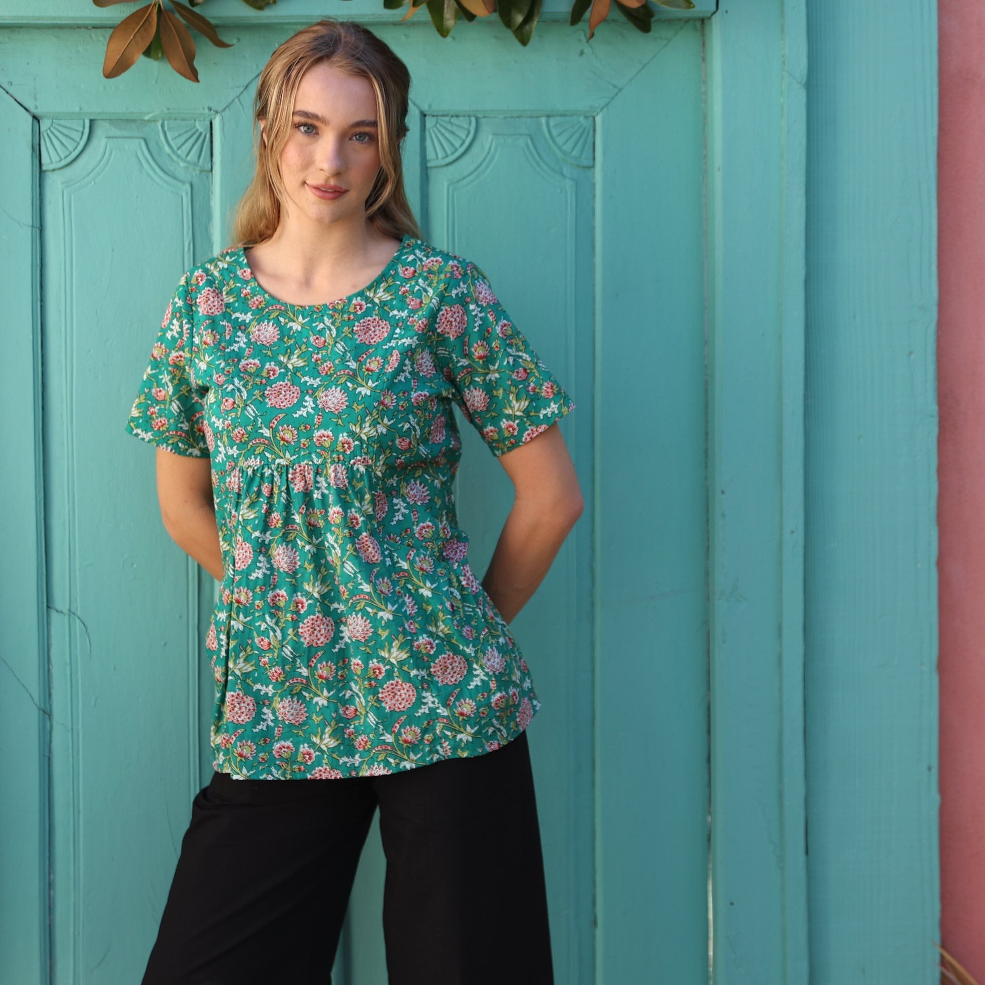 woman wearing black cotton top with round neck and cap sleeve