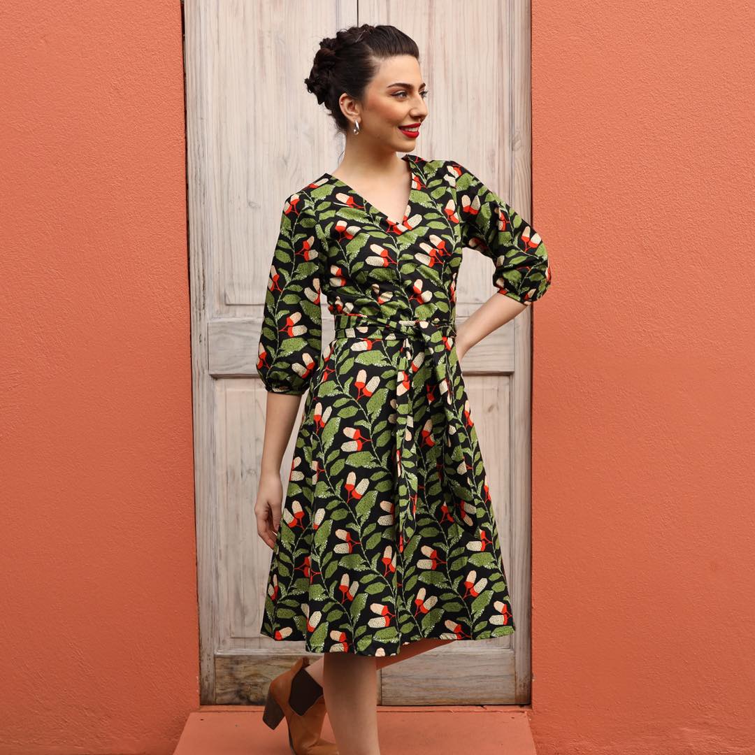 woman wearing long sleeve cotton wrap dress in black and green