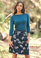 Woman wears gorgeous floral print on dark blue base cotton corduroy skirt