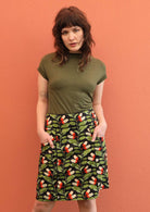 Model wears green and black print cotton A-line skirt