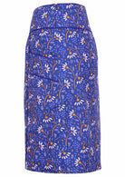 Blue based skirt with an orange and off white daisy print. 