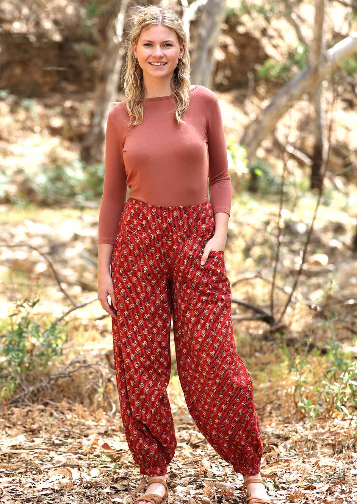 Lightweight cotton pants with black and burnt umber flowers on a deep red base