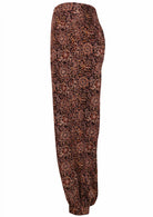 100% cotton floral printed brown pants with pockets and cuffed buttoned ankles 