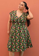 Plus size model wearing retro style cotton Alice dress black and green with pockets